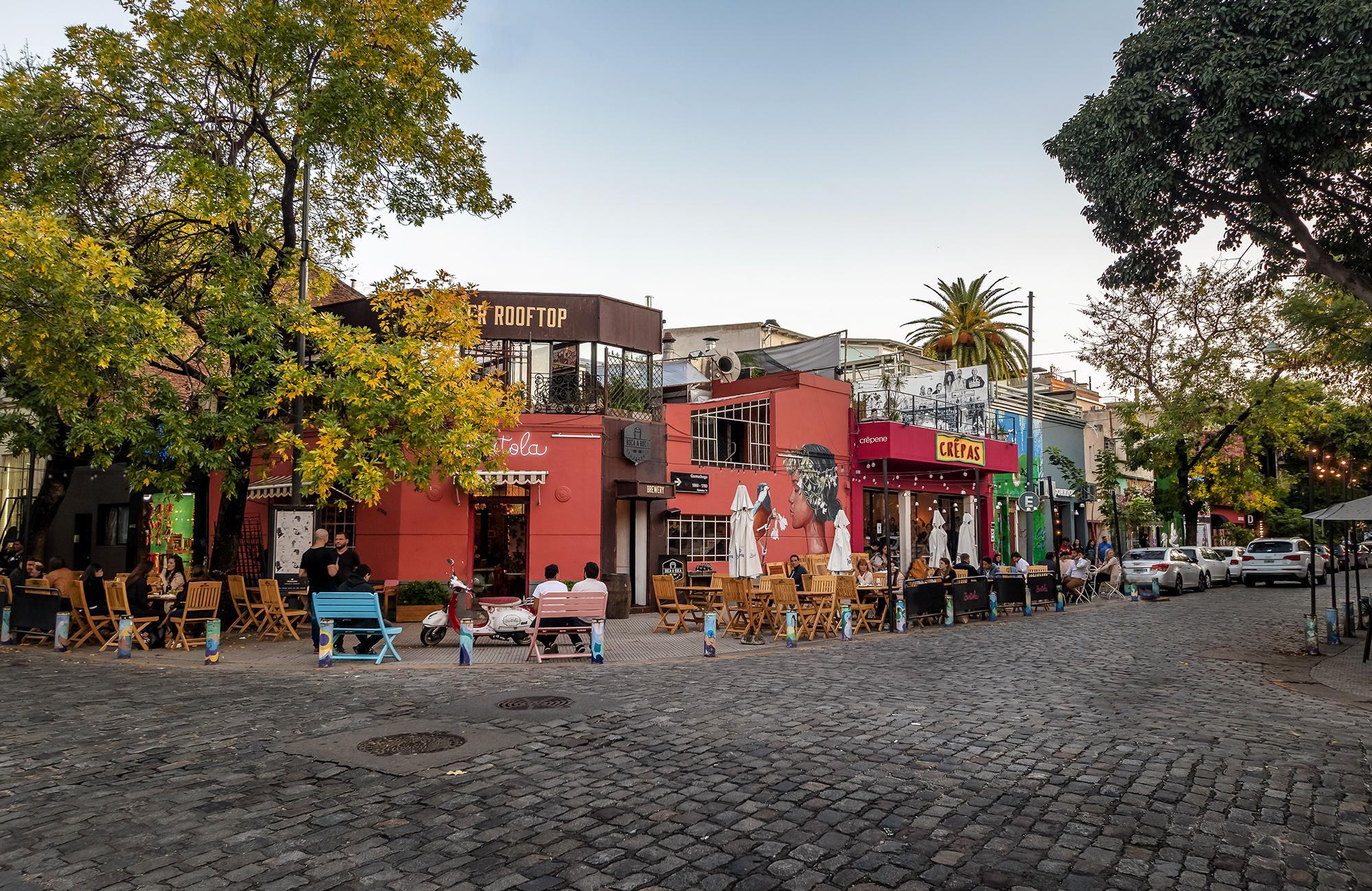 <h3> BARRIO DE PALERMO </h3>Palermo is a sprawling and vibrant neighborhood in Buenos Aires, Argentina, known for its eclectic mix of cultural, culinary, and recreational offerings. It is the largest neighborhood in the city and is divided into several sub-areas, each with its distinct character. Palermo Soho and Palermo Hollywood are famous for their trendy bars, restaurants, boutique shops, and lively nightlife. Palermo Viejo, the older part of the neighborhood, boasts charming cobblestone streets and historic buildings. The area also features vast green spaces like the Bosques de Palermo (Palermo Woods), which include parks, gardens, and the Buenos Aires Zoo. Palermo is a hub of activity, attracting both locals and tourists with its dynamic atmosphere and diverse attractions. 