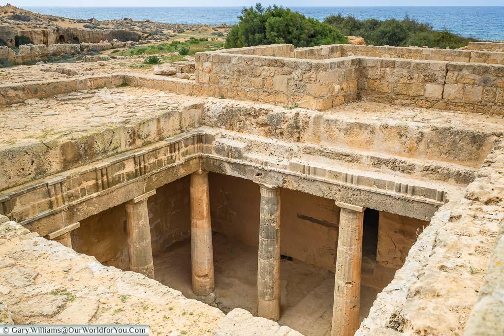 <h3>TOMBS OF KINGS</h3>Located just north of Paphos harbor, the Tombs of the Kings is a large necropolis dating back to the 4th century BC. Carved out of solid rock, these underground tombs served as the final resting place for high-ranking officials rather than kings. The site is notable for its impressive architecture and elaborate burial chambers, providing insight into ancient Cypriot burial practices.