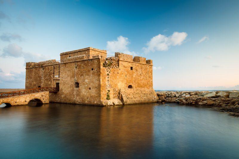 <h3>PAPHOS CASTLE</h3>Situated at the edge of Paphos Harbor, this medieval fortress dates back to the 13th century and has undergone several renovations over the centuries. Originally built by the Lusignans, it was later dismantled by the Venetians and rebuilt by the Ottomans. Today, Paphos Castle is a prominent landmark and cultural venue, hosting concerts, festivals, and exhibitions throughout the year. 