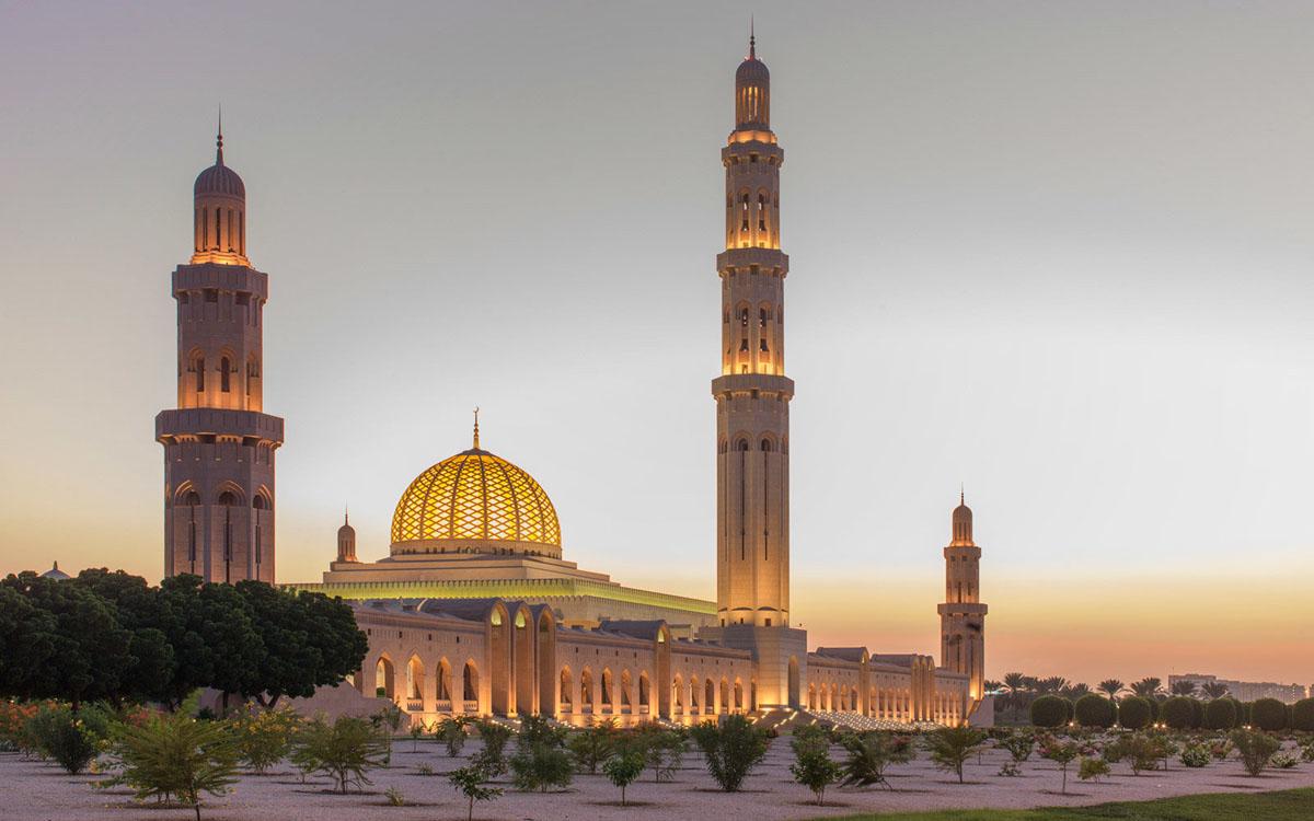 <h3>SULTAN QABOOS GRAND MOSQUE</h3>The Sultan Qaboos Grand Mosque in Muscat is a magnificent example of modern Islamic architecture and a symbol of Oman's religious devotion and cultural pride. Completed in 2001, the mosque was named after Sultan Qaboos bin Said al Said, the former Sultan of Oman who initiated its construction. It features a blend of traditional Islamic design elements with contemporary touches, including a massive main prayer hall adorned with a grand Persian carpet that holds the Guinness World Record for the world's largest hand-woven carpet. The mosque's exterior is characterized by its gleaming white marble, intricate calligraphy, and towering minarets that reach up to 90 meters in height. Visitors are awed by the sheer scale and beauty of the mosque, which can accommodate thousands of worshippers. The Sultan Qaboos Grand Mosque stands as a testament to Oman's religious tolerance, architectural prowess, and reverence for Islamic traditions.