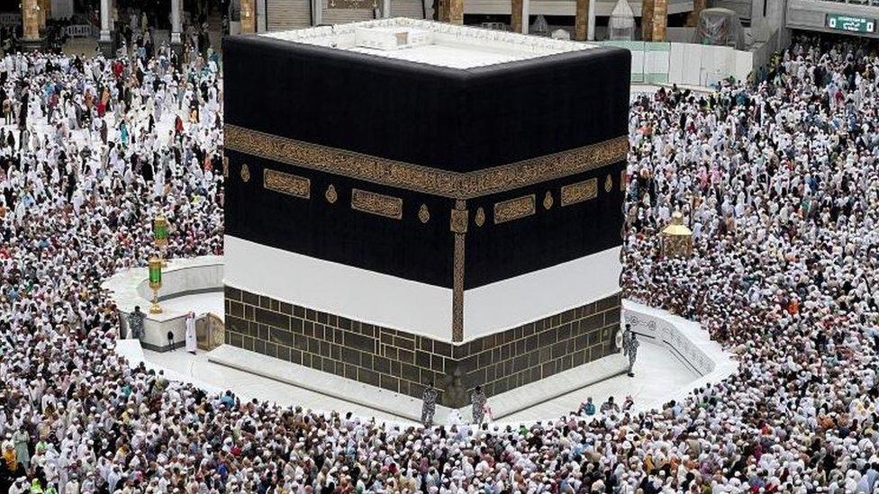 <h3>THE KAABA</h3>The Kaaba is the holiest site in Islam, located within the Masjid al-Haram (Grand Mosque). It is a cuboid structure draped in black cloth (kiswah) adorned with Quranic verses. Muslims face the Kaaba during prayers and perform Tawaf (circumambulation) around it as part of their pilgrimage rituals.