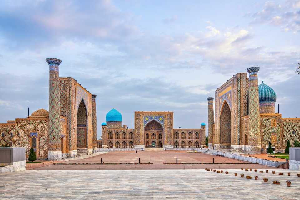 <h3>REGISTAN SQUARE </h3>This iconic square is the heart of Samarkand, adorned with three grand madrasahs (Islamic schools) dating back to the 15th and 17th centuries. The intricate tile work and majestic architecture of the Ulugh Beg Madrasah, Tilya-Kori Madrasah, and Sher-Dor Madrasah make Registan Square a UNESCO World Heritage site and a symbol of Samarkand's cultural splendor.